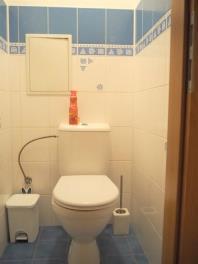 Kompaktní koupelna s keramickými obklady, modrobílý dekor, světlý interiér, čistý a moderní styl.